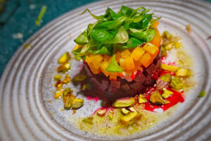 Artfully presented appetizer of seafood and fresh produce at Michelin Star restaurant